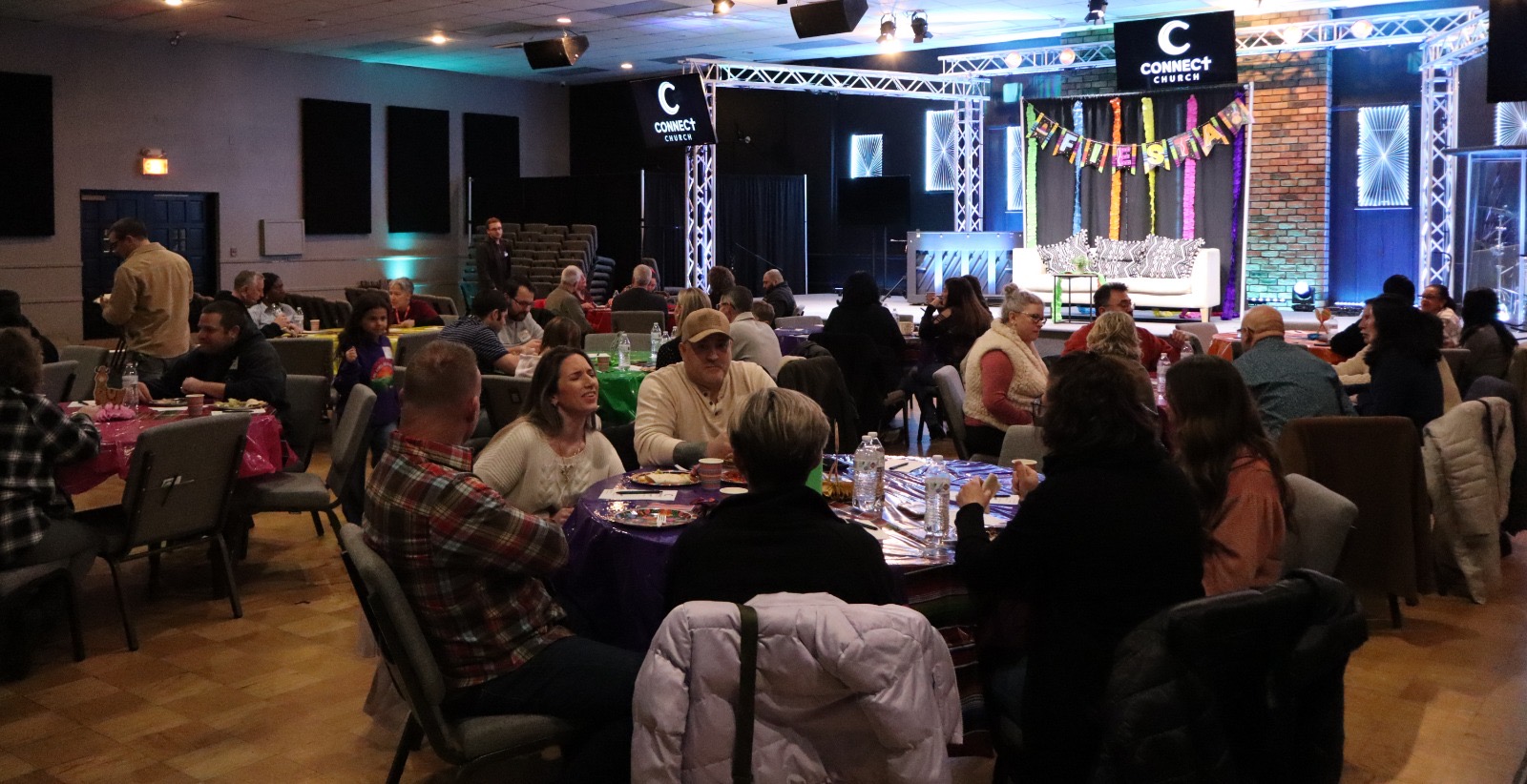 People sharing conversation around tables at Connect Church